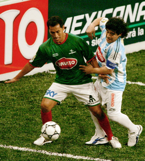 Benjamin Galinfo (L) from Mexico figths for the ball with Diego Armando Maradona
(R) of Argentina during their friendly match "Showbol" at the Palace Sport in
Mexico City November 11th 2006, as part of his Latin American countries tour.  ...